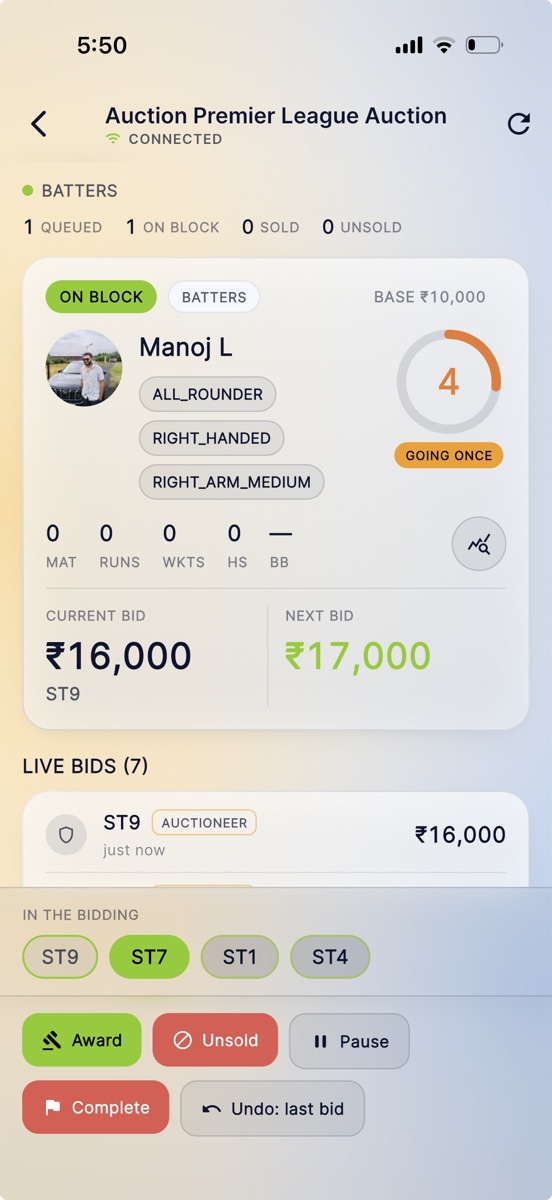 An auctioneer running a live player auction from a phone